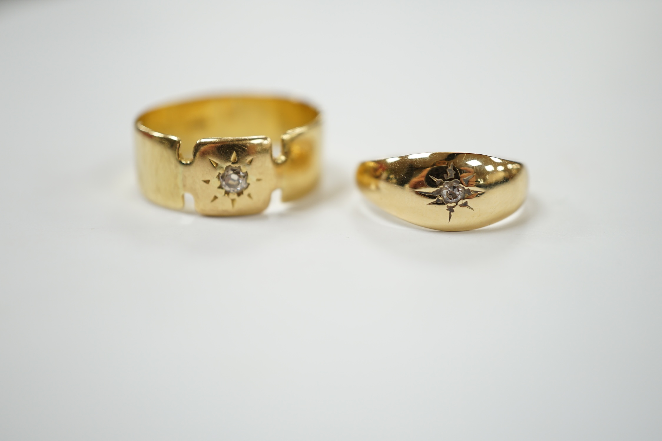 Two 18ct and single stone diamond chip set bands, largest size S, gross weight 7.7 grams. Condition - fair
